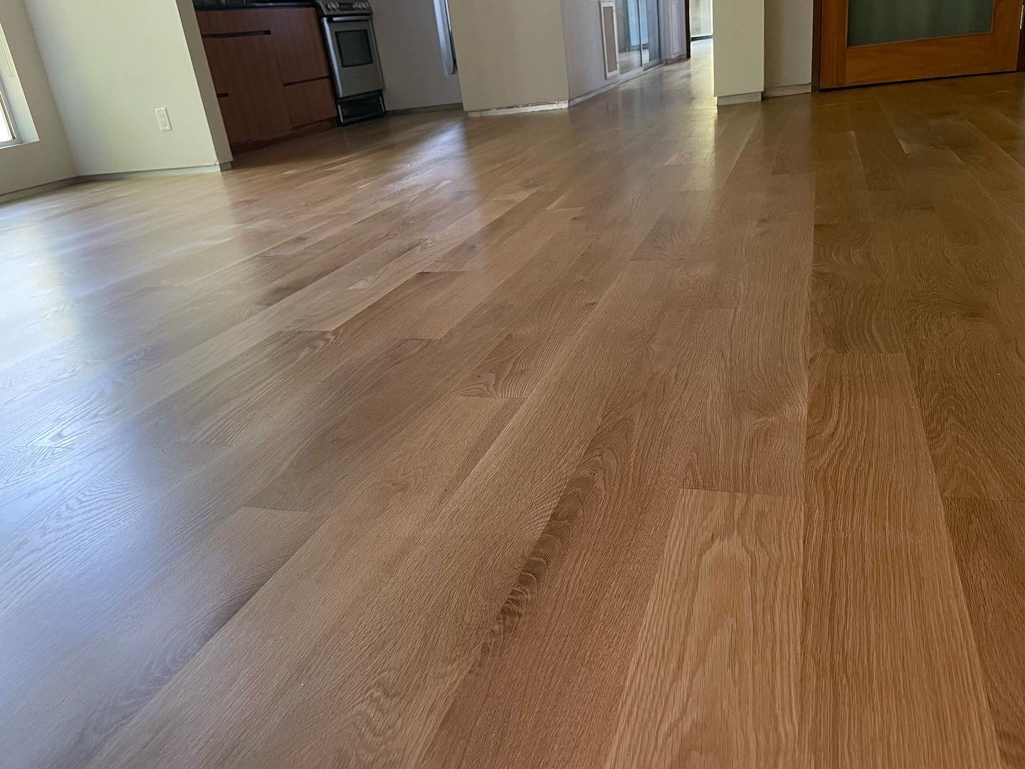 Finished hardwood floor running through the open living space