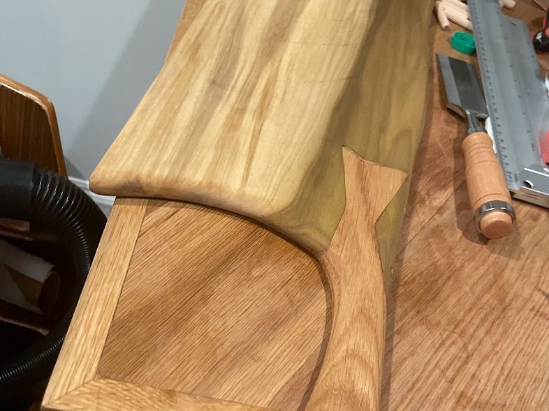 Live-edge serving board being shaped on the bench