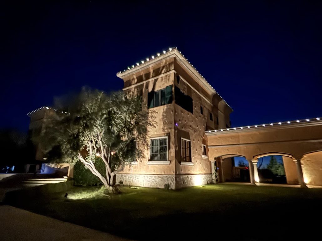 Side elevation with uplighting to walls and trees
