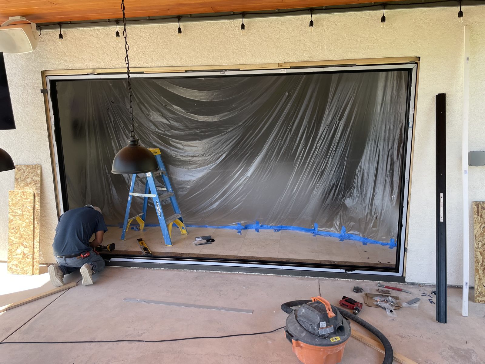 Folding glass door track being set in the opening